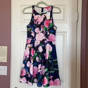 Betsey Johnson fit and flair dress in floral print. Features pink roses, size 6.